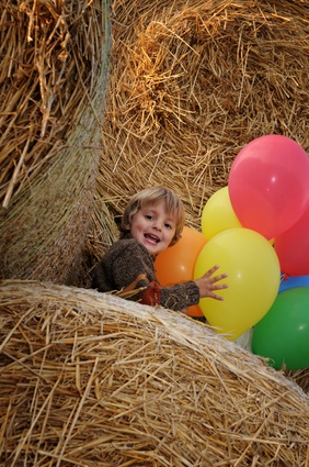 Bild zeigt spielendes Kind im Stroh